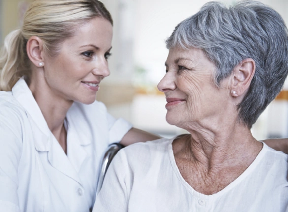 Happy Senior Smiling and Speaking with Medical Professional
