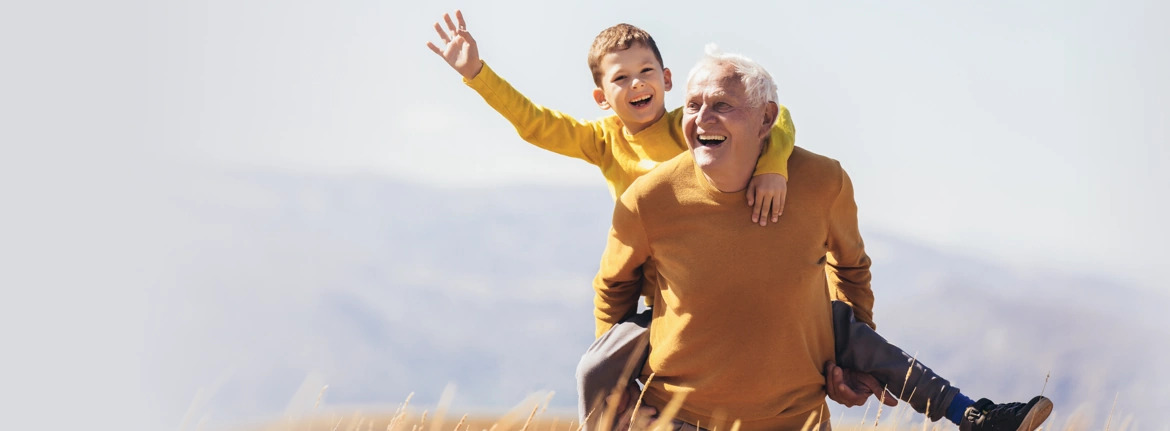 Two Independent Seniors Walking Bikes Along Beach