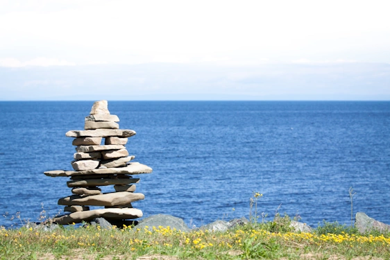 Northwest territories inukshuk picture with lake background