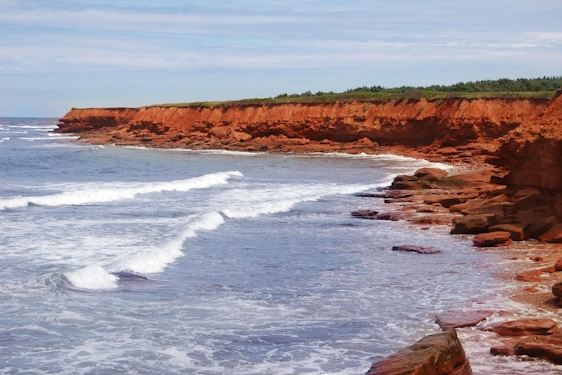 Prince Edward Island red sandstone beach with blue skies and water