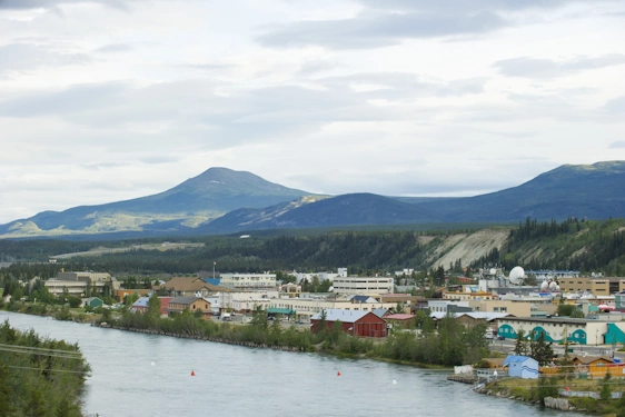 Yukon Whitehorse city river image with mountains on the background